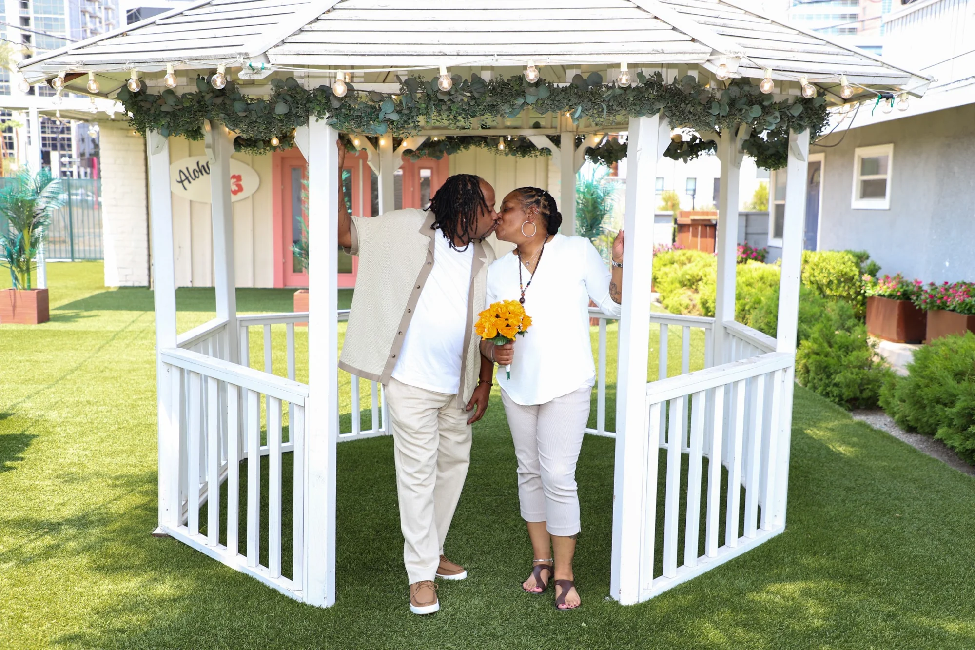 Newlywed couple posing in outdoor gazebo Las Vegas wedding