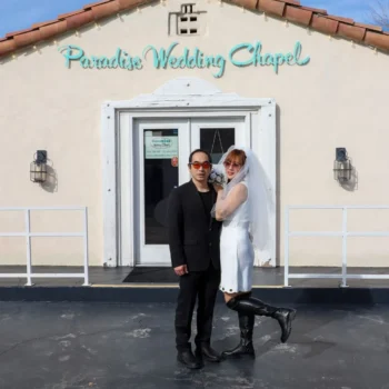 Couple posing playfully outside Las Vegas wedding chapel