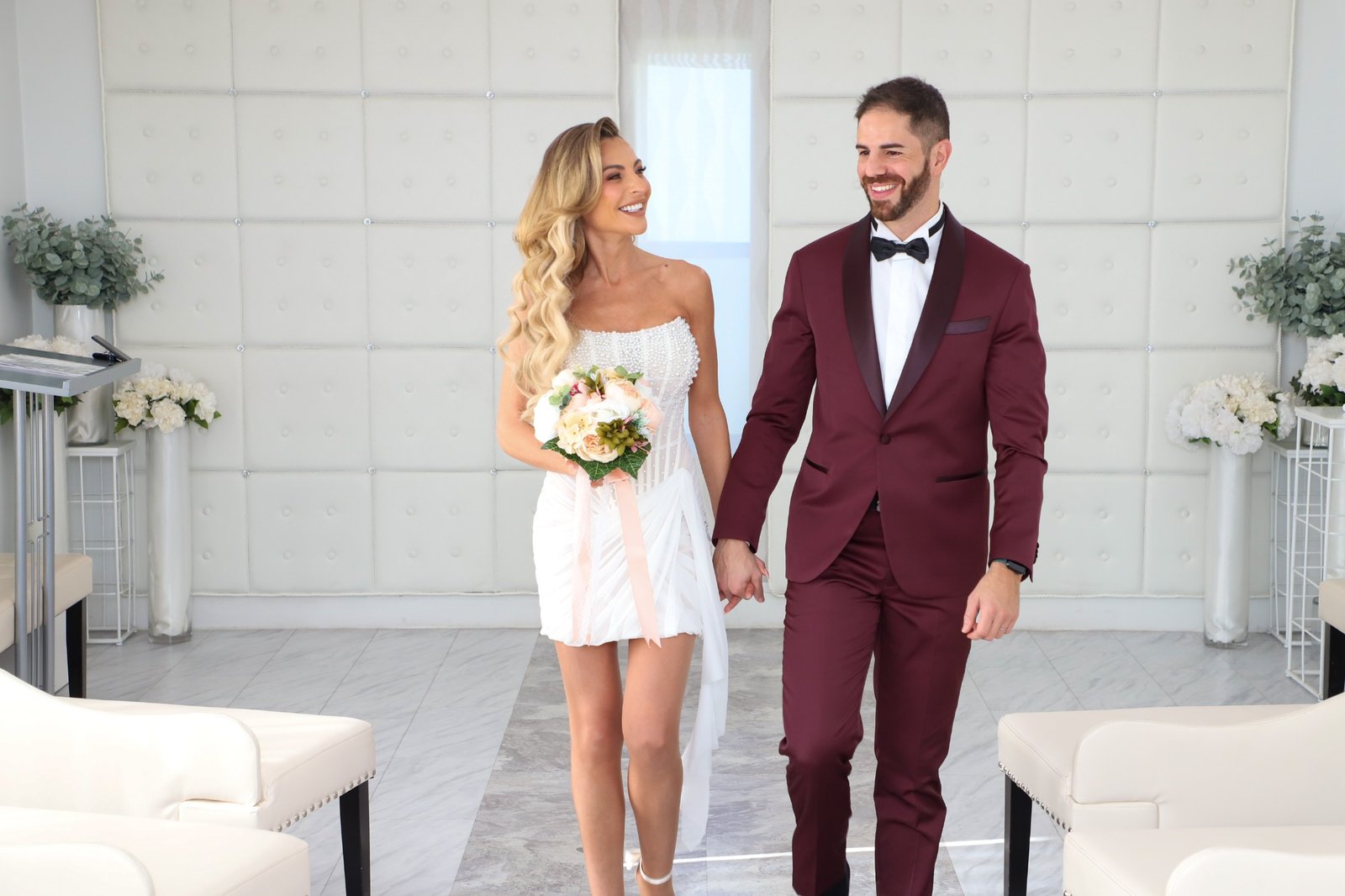 Smiling newlyweds walking together through Las Vegas wedding chapel