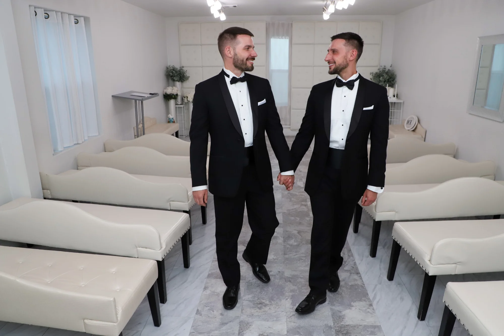 groom and groom walking together inside Las Vegas wedding chapel